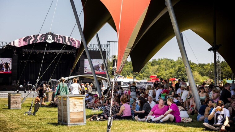 Festivalgangers zoeken verkoeling op een van de schaduwplekken op de eerste dag van Pinkpop 2026